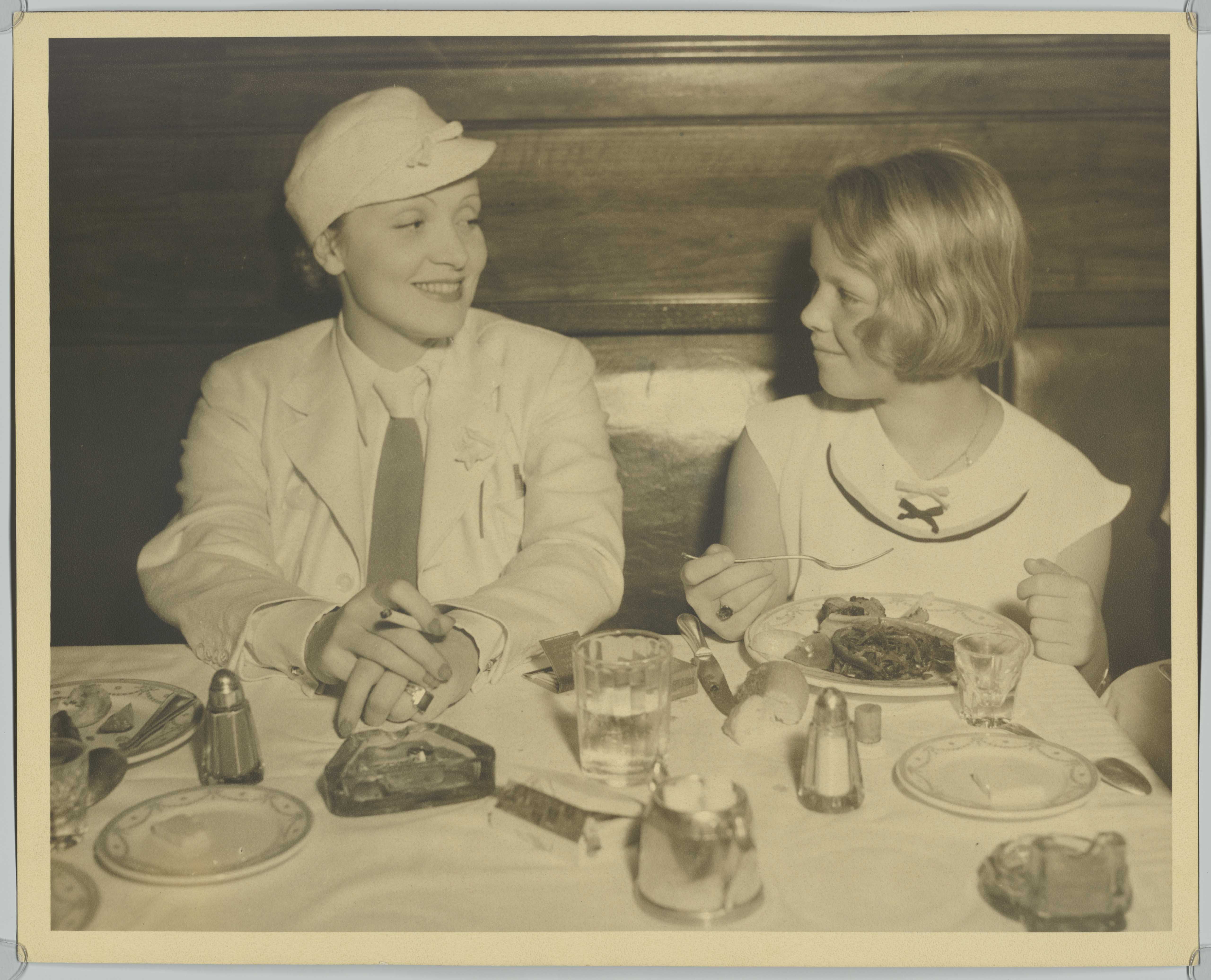Marlene Dietrich visits a restaurant with daughter Maria, Los Angeles, March 1934