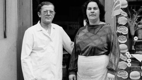 The Dahms couple stand in front of their bakery store in a black and white photograph from 1987.